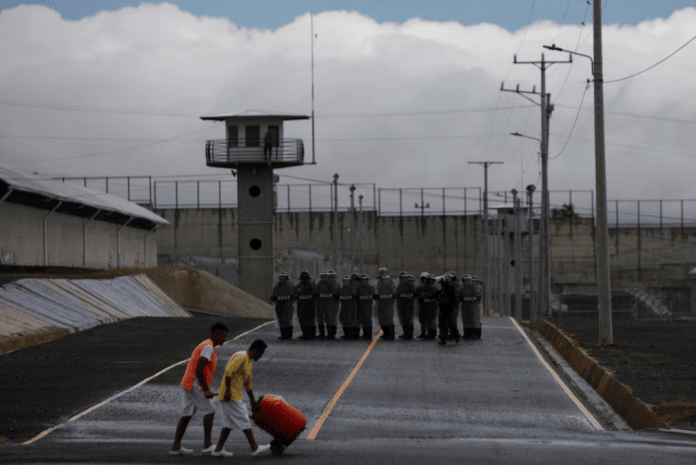 Wardens in anti-riot gear take part in a practice, during a tour in the 
